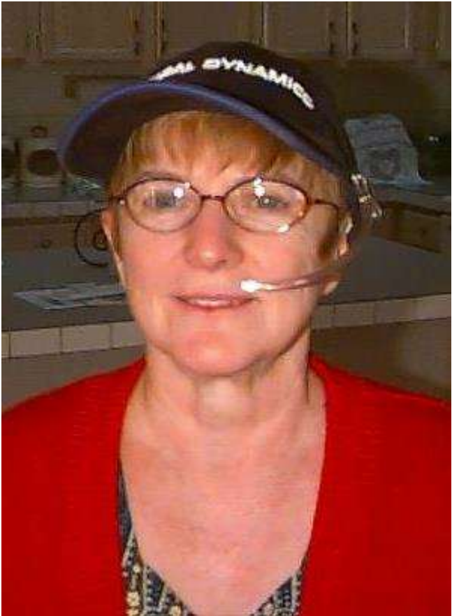 Close-up photo of a woman wearing a hat and a headset