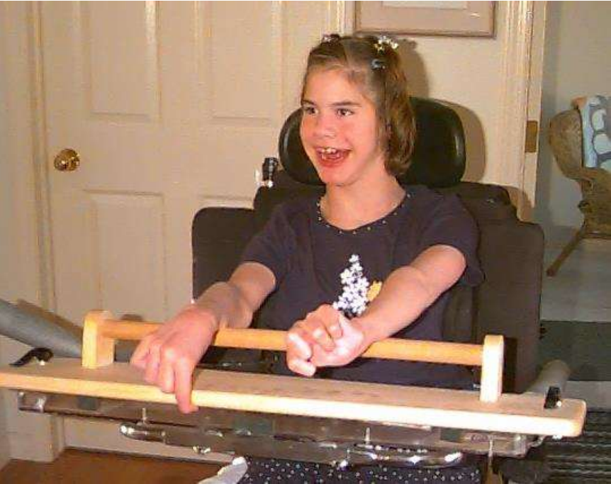 Young girl smiling in a wheelchair