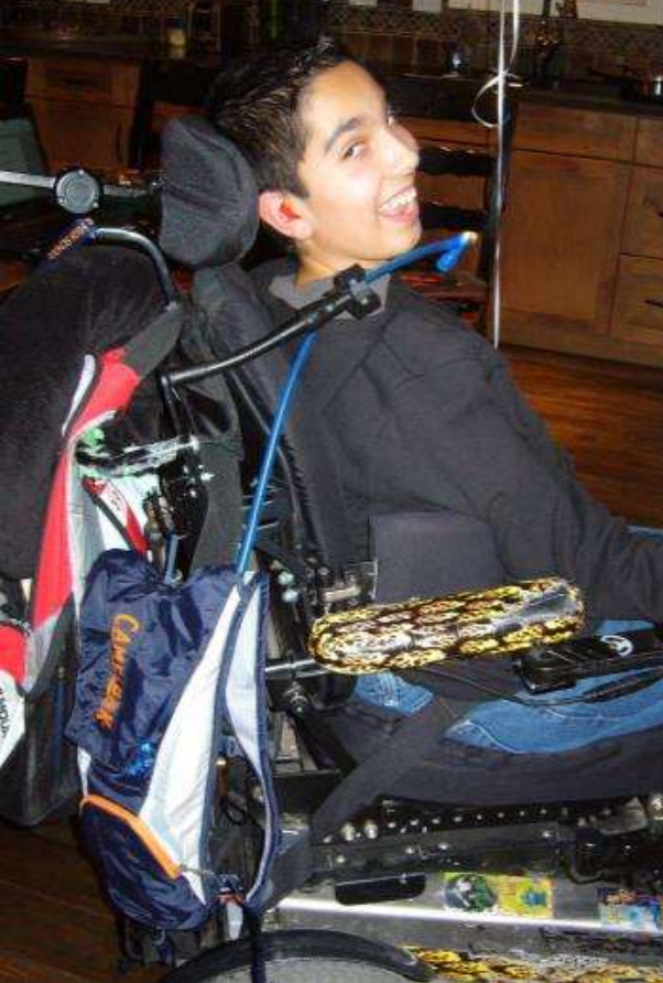 Boy smiling in a wheel chair